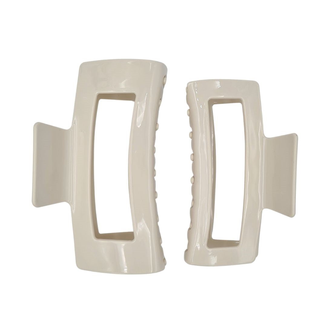 large claw clip in cream beige extra large claw clip size is on the left and large claw clip is on the right
