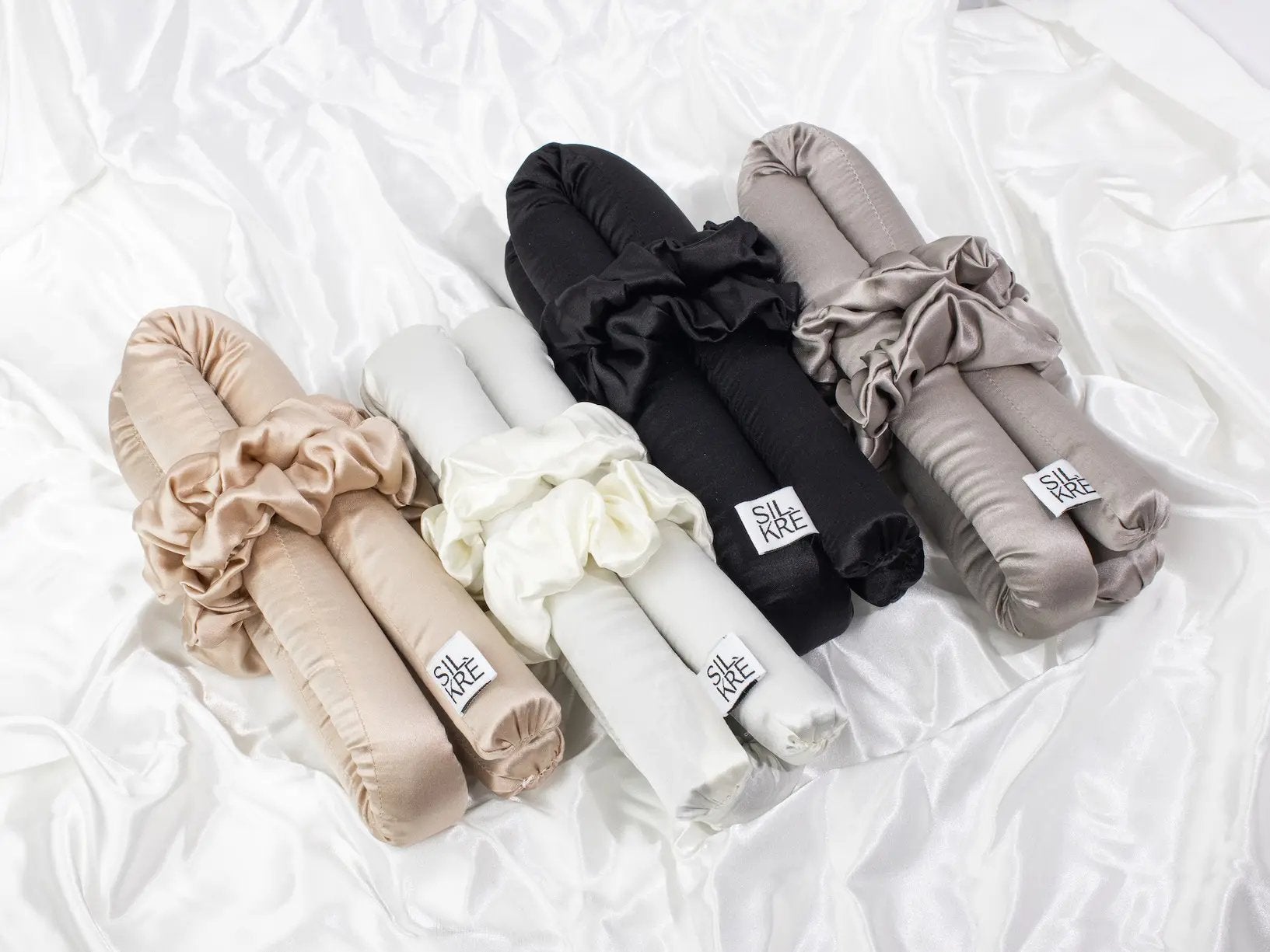 heatless hair silk curling set in champagne cream black grey on a silk backdrop flat lay