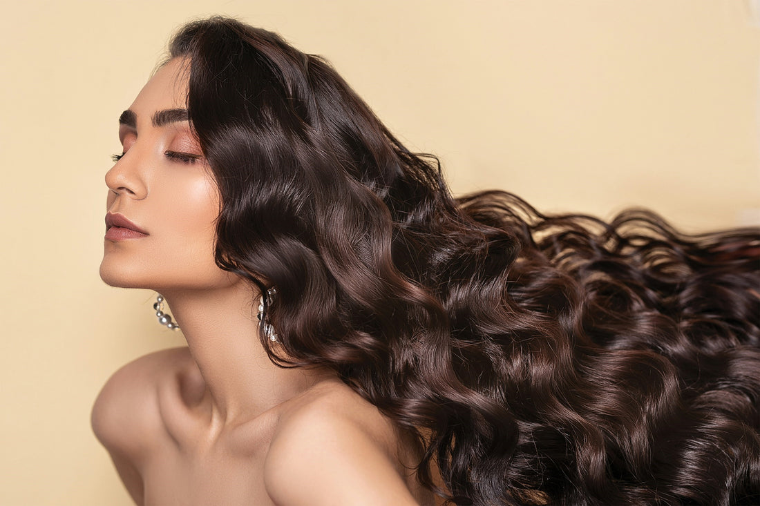 woman with healthy long curly hair on a pastel yellow background