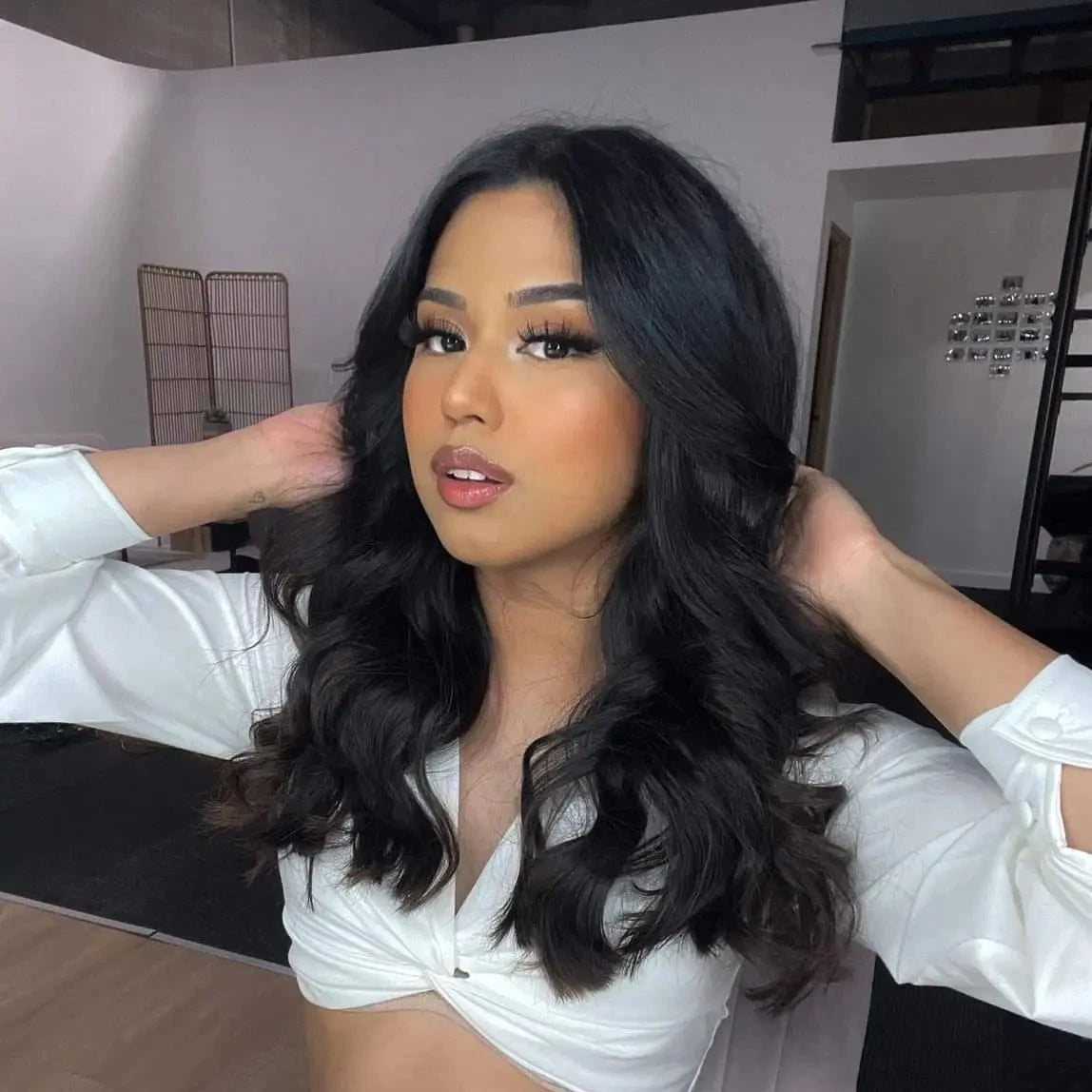 Woman with black hair that is curled using a heatless curler